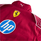Red racing jacket close-up with Ferrari crest, blue HP logo, and shoulder stripe detailing